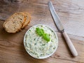 Herb butter in a bowl on wood