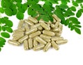 Herb capsule with green herbal leaf on white background Royalty Free Stock Photo