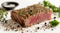Herb-crusted seared tuna steak, medium rare, with peppercorns and fresh greens