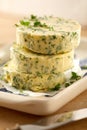 Herb flavored butter pats with fresh parsley