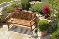 Herb garden and bench with little apple tree Royalty Free Stock Photo