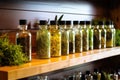 herb infused oils lined on a lighted shelf Royalty Free Stock Photo