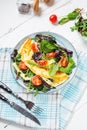 Herb omelette with cheese, cherry tomatoes and arugula on wooden background. Breakfast