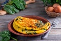 Herb omelette with spinach on plate on the table