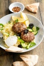 Herb turkey patties served with couscous and fresh salad