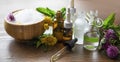 Herbal aromatherapy oils and bath salt with medicinal plants and herbs, essential oils bottles