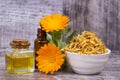 Herbal calendula officinalis in the glass and drop oil Isolated