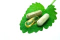 Herbal capsules on melisa leaf Royalty Free Stock Photo