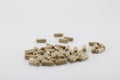 Herbal capsules placed on a white background.