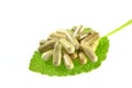 Herbal capsules on sage leaf