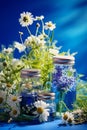 Herbal extracts in bottles on a blue background. Generative AI,