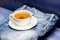 Herbal green or black whole leaf. Mug filled boiling water and tea bag on blue jeans background. Healthy habits. Tea