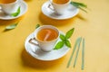 Herbal green tea with lemongrass in glass cup with fresh limes. Top view of three white cups of Lemon Grass Drink on a Yellow Royalty Free Stock Photo