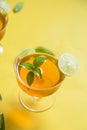 Herbal green tea with lemongrass in glass cup with fresh limes. Top view of two cups of Lemon Grass Drink on a Yellow Background