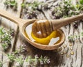 Herbal honey pouring into the wooden spoon. Royalty Free Stock Photo