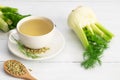 Herbal infusion fennel tea in glass cup or mug with dried fennel seeds and fennel bulbs