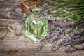 Herbal lavender oil with fresh flowers bouquet on wooden backgro Royalty Free Stock Photo