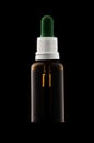 Herbal medicine or aromatherapy dropper bottle isolated on black Royalty Free Stock Photo