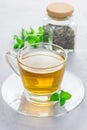 Herbal mint tea in glass cup with dry peppermint tea on background, vertical Royalty Free Stock Photo