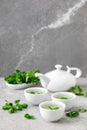 Herbal mint tea in small traditional chinese cups and fresh leaves