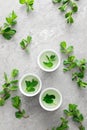 Herbal mint tea in small traditional chinese cups and fresh leaves