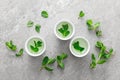 Herbal mint tea in small traditional chinese cups and fresh leaves