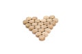 Herbal pills form heart shape isolated