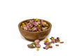 Herbal rose tea in wooden bowl isolated