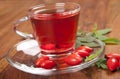 Herbal rosehip tea with fresh fruits on wooden background Royalty Free Stock Photo