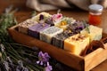 Herbal soap on a wooden tray made with natural ingredients such as lavender, chamomile and calendula