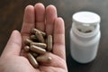 Herbal supplement capsule in hand.  Lingzhi or Reishi mushroom capsules Royalty Free Stock Photo