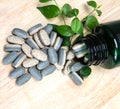 Herbal Supplement vitamin pills or tablets on wooden plate Royalty Free Stock Photo