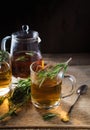 Herbal tea with aromatic rosemary on wood table Royalty Free Stock Photo