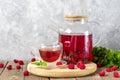 Herbal tea with berries, raspberries, mint leaves and hibiscus flowers in glass teapot and cup on wooden table Medicine for cold Royalty Free Stock Photo