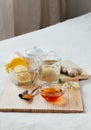 Herbal tea with chamomile flowers, turmeric and honey on a wooden board. Treatment of hot drink ginger. folk remedies Royalty Free Stock Photo