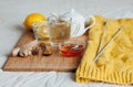 Herbal tea with chamomile flowers, turmeric and honey on a wooden board. Treatment of hot drink ginger. folk remedies Royalty Free Stock Photo