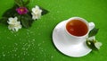 Herbal tea cup. Fresh, healthy,hot tea, bouquet of spring flowers jasmine, wild rose on a green woolen tablecloth. Royalty Free Stock Photo