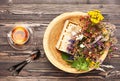 Herbal tea cup, healing herbs and honey in a wooden bowl on a wooden table Royalty Free Stock Photo