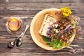 Herbal tea cup, healing herbs and honey in a wooden bowl on a wooden table Royalty Free Stock Photo