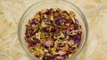 Herbal tea dried blend mixture of rose glass jar cup, cornflower, hibiscus, thyme leaf petals and mother-of-tea for teas Royalty Free Stock Photo