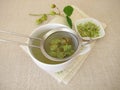 Tea with dried hop flowers in tea strainer Royalty Free Stock Photo