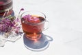 Herbal tea from fermented kipreya leaves in a glass Cup on a light background