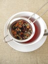 Herbal tea with fruits and flowers in tea strainer Royalty Free Stock Photo