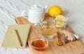 Herbal tea in glass cup with flowers of chamomile, turmeric and honey on a wooden board. Royalty Free Stock Photo