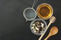 Herbal Acaccia Tea Healthy Drink in bowl and sieve over Black Background copy space. Healthy Drink, coldness.