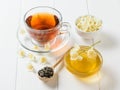 Herbal tea, honey, Jasmine flowers and a wooden spoon on a rustic white table. The composition of the morning Breakfast.