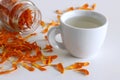 Herbal tea made from Calendula officinalus, or the Pot Marigold, with fresh orange flowers used as a colourant in Royalty Free Stock Photo