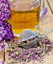 Herbal tea from oregano with strainer in glass mug Royalty Free Stock Photo