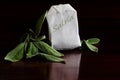 Herbal tea, salvia leaves and tea bag, dark background