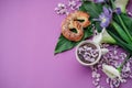 Herbal tea with wisteria, irises, white callas on violet background. Royalty Free Stock Photo